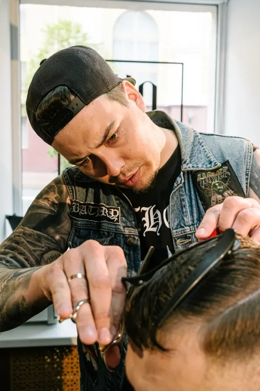 Barber carefully cutting a client hair