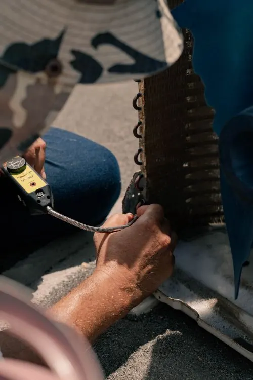 Technician servicing an air conditioning unit